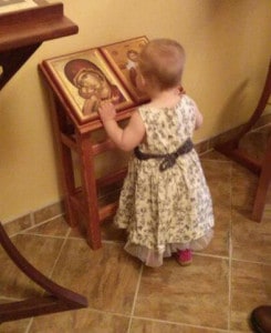 Children rarely seem to need to be taught how to venerate icons. This photo is from St Anne Orthodox Church in Oak Ridge, Tennessee. The child-sized analogion was built by the rector, Fr. Stephen Freeman. Image by Magda Andronache.